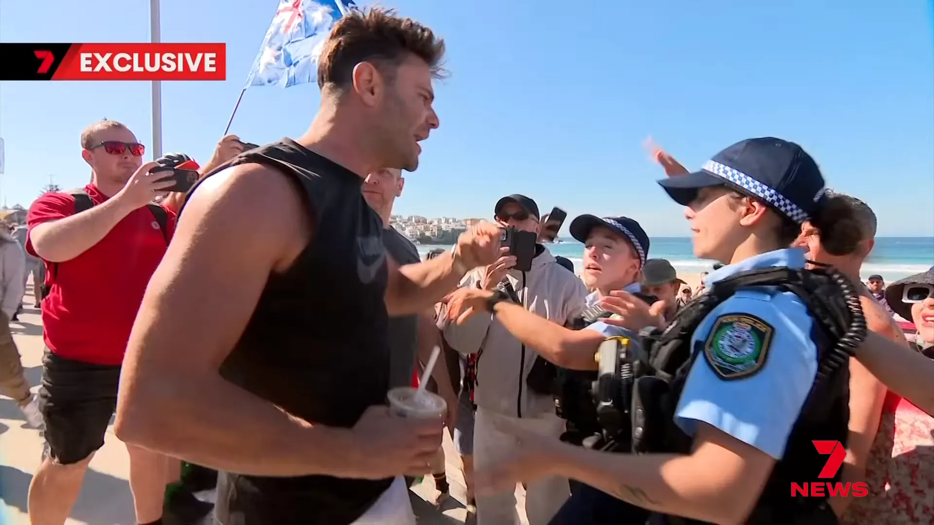 Protesters guided off the sand by police as tensions rise