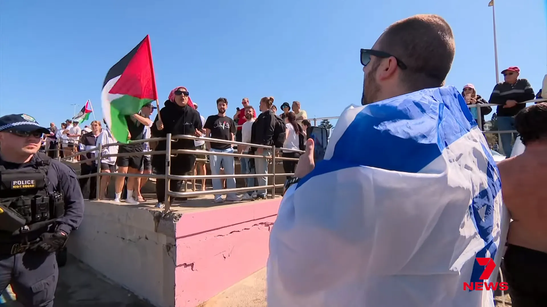 Police form a thin line between rival groups at Bondi