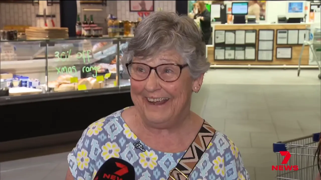older woman smiling during an interview inside a supermarket at the Colonnades shopping centre