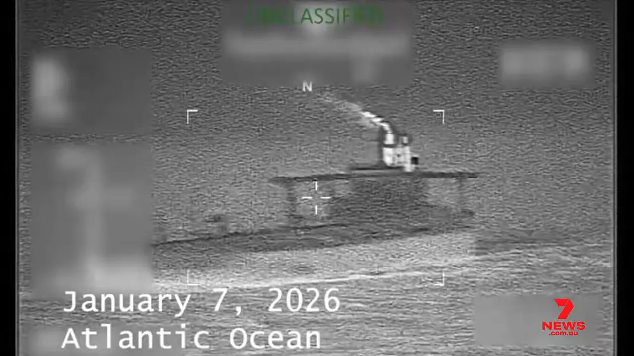 Night-time surveillance image of a tanker at sea with overlaid text 'January 7, 2026' and 'Atlantic Ocean' and a targeting reticle.
