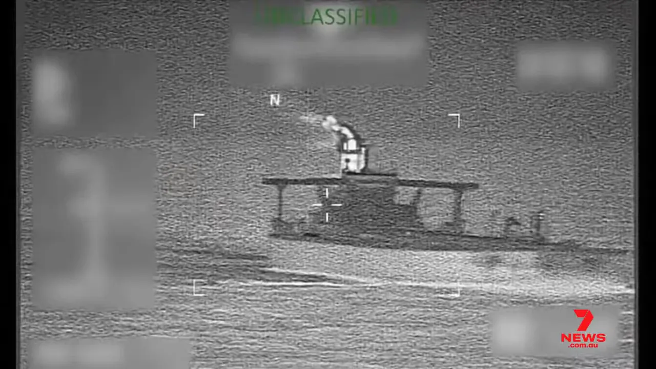 Thermal surveillance view of suspected tanker at sea with hull and superstructure visible