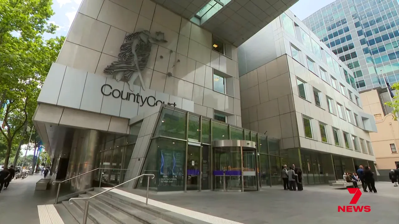 Wide exterior shot of Melbourne County Court entrance with people gathered outside.