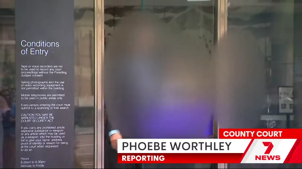 Blurred figures exiting a county court entrance with reporting lower-third visible