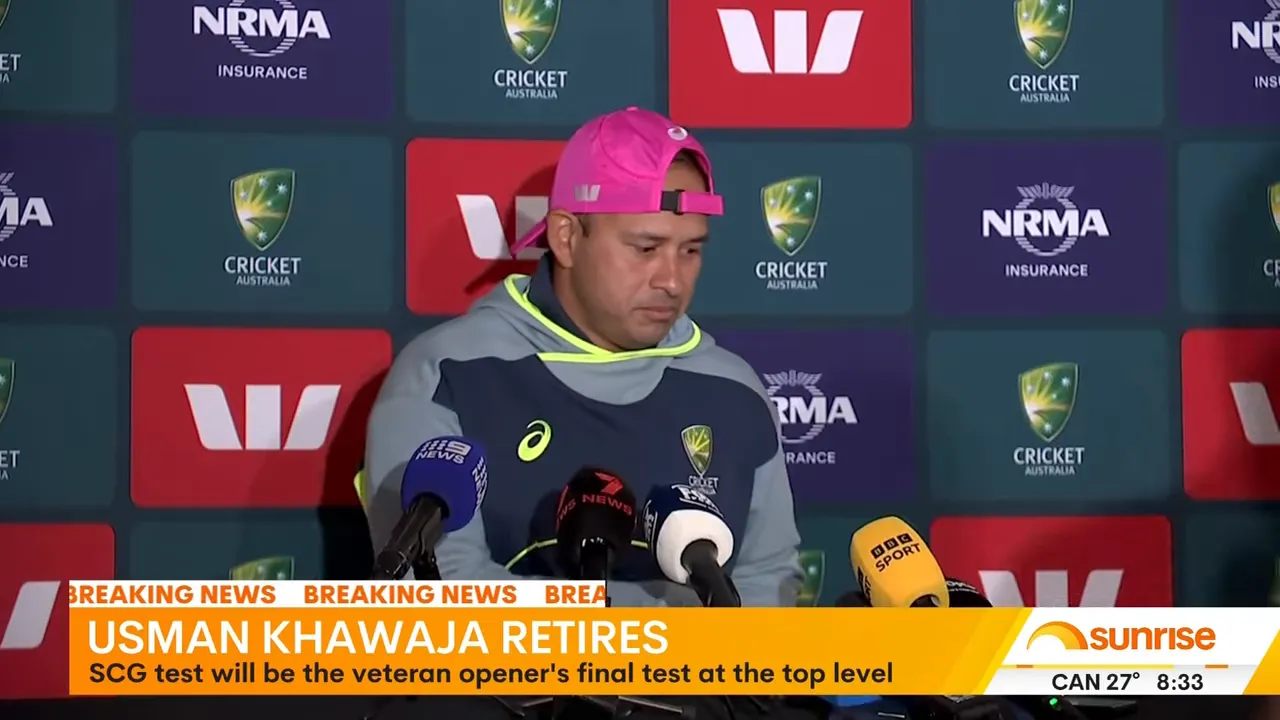 Cricketer standing at a press-conference backdrop with microphones in front