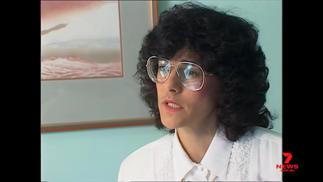 adult expert interviewed on camera in an office setting wearing glasses