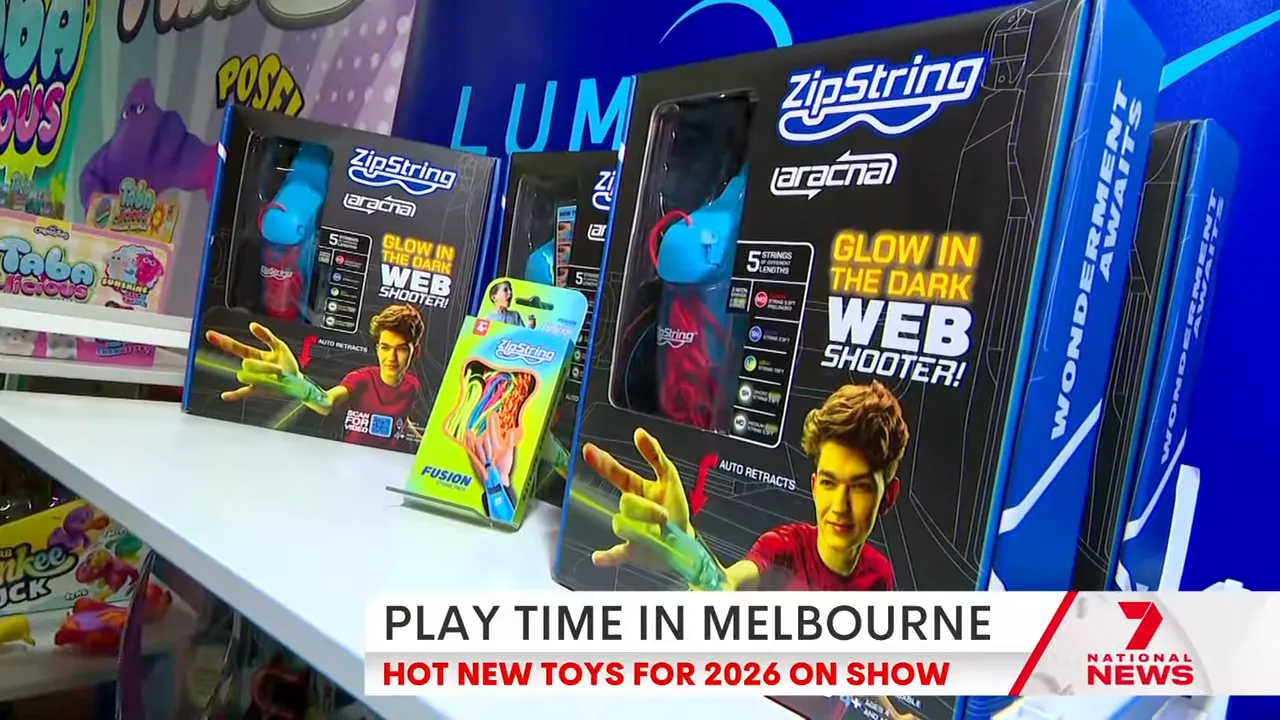 Close-up of ZipString Arcana boxed web-shooter toys on a display shelf at a toy fair.