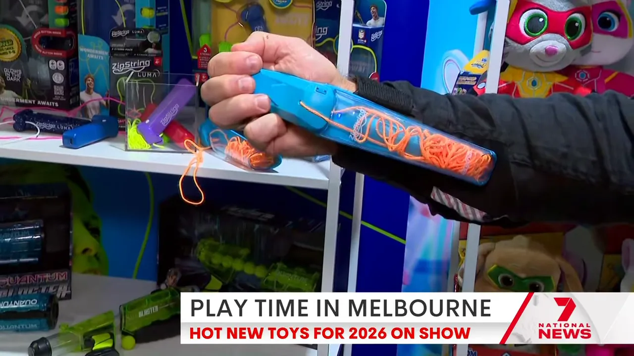 Arm‑strapped ZipString Arcana web‑shooter extended, showing the orange filament and wrist strap.