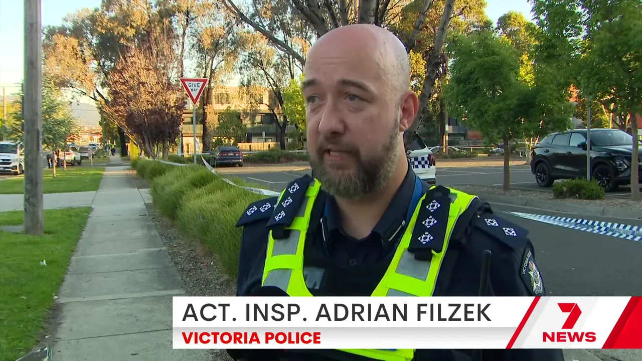 Emergency crews treating the injured man near a block of units