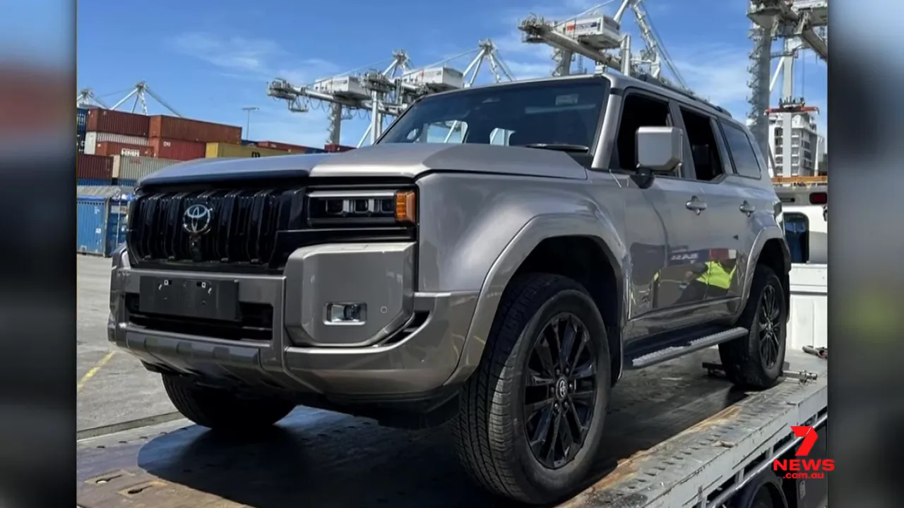 recovered Toyota Land Cruiser on a ramp at the Port of Brisbane with container cranes in the sky behind