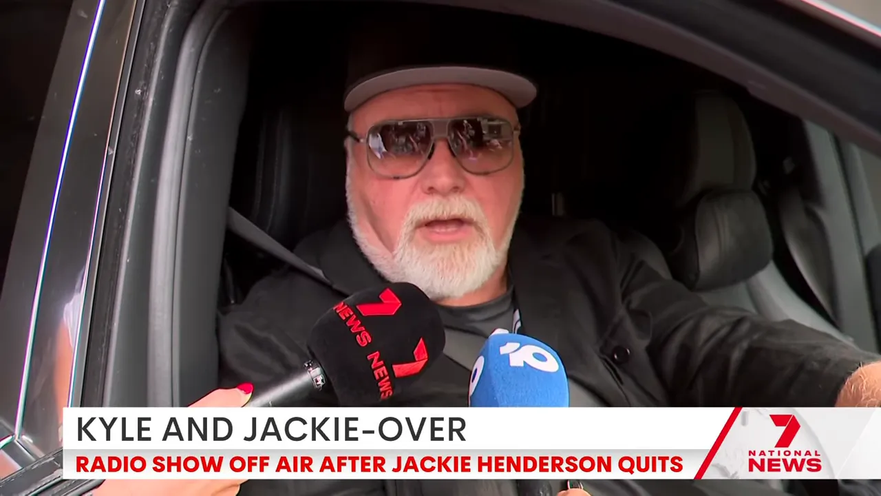 male presenter giving guarded remarks to reporters from inside a car