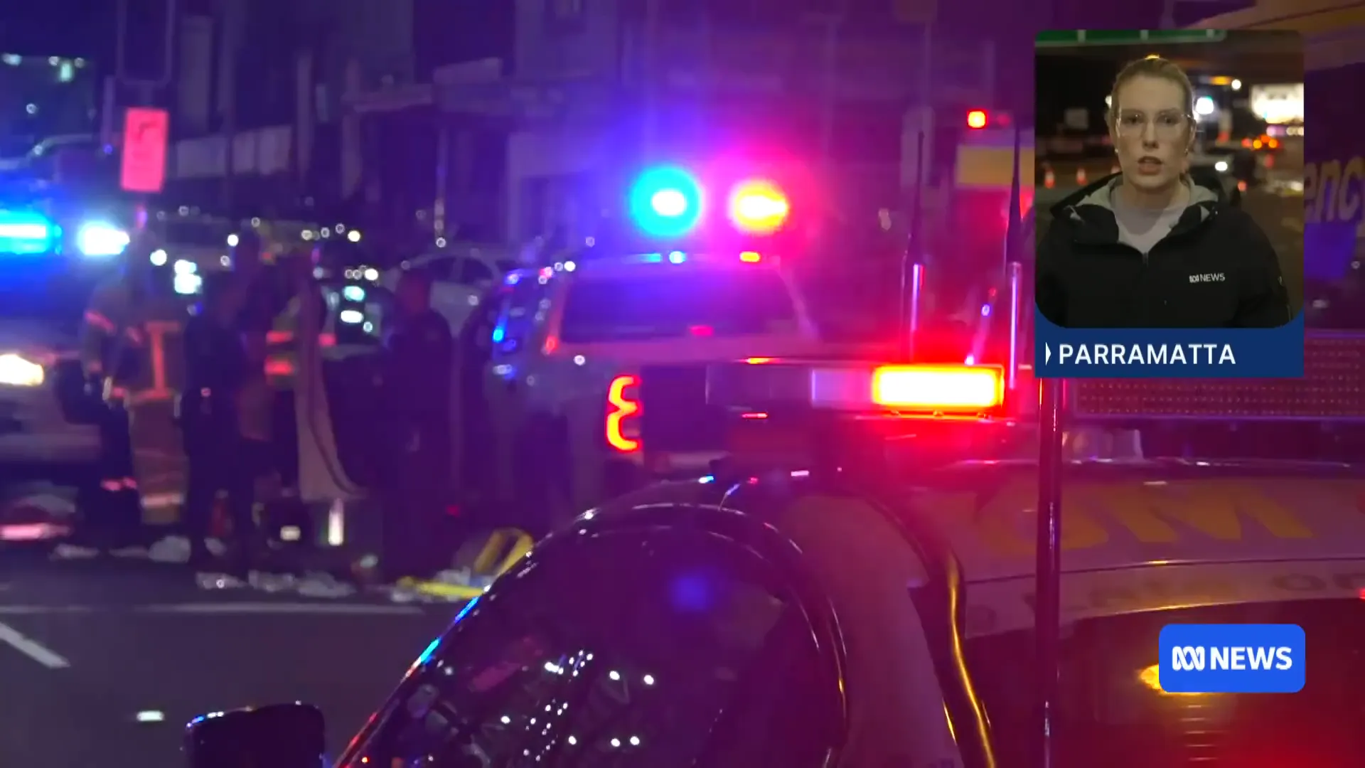 Paramedics treating one of the injured men after the shooting in Parramatta