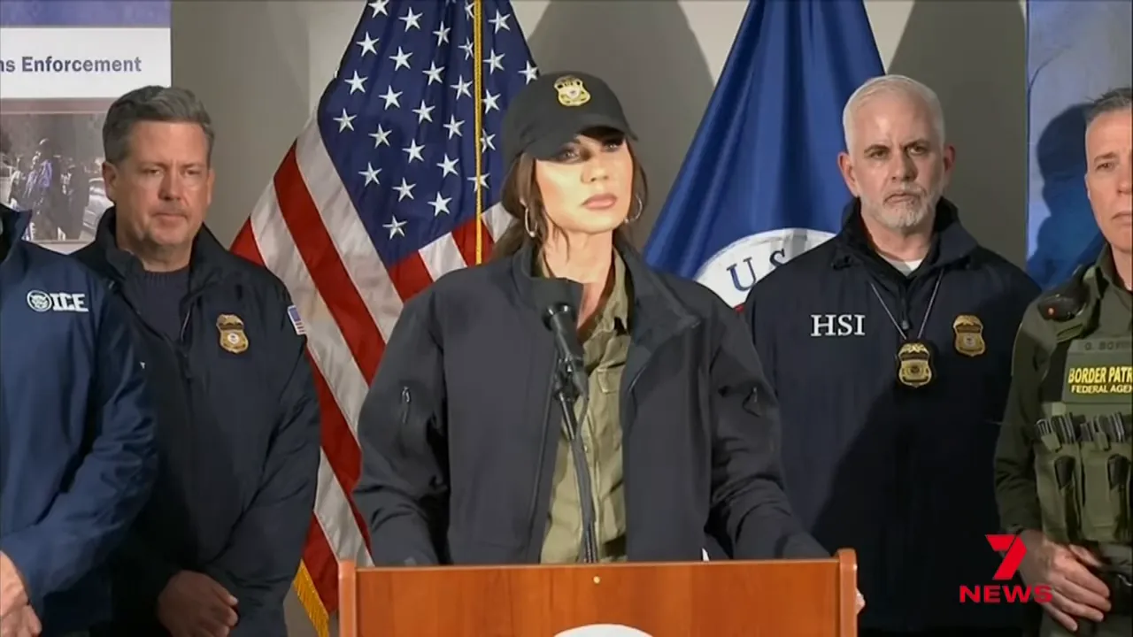 Wide shot of press conference with speaker at podium and federal officials