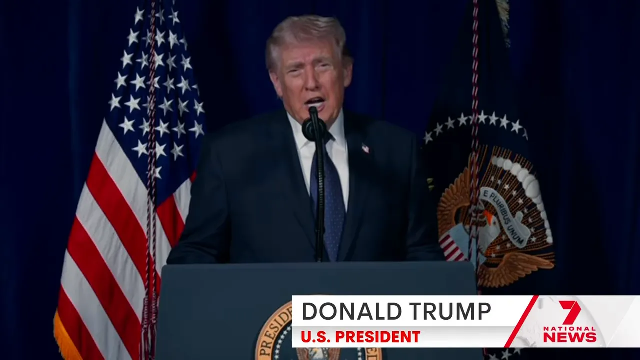 clear shot of a person speaking at a podium flanked by US flags and the presidential seal