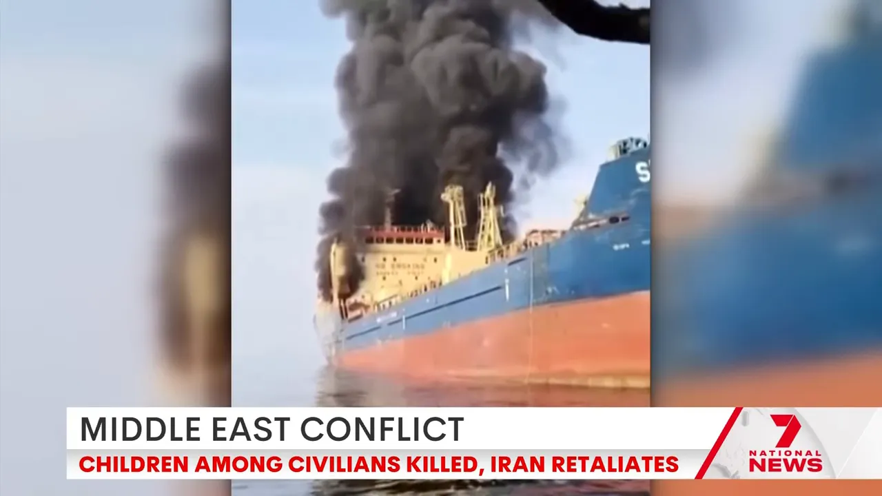 Clear image of a cargo ship with heavy black smoke rising after an apparent attack in the Persian Gulf.