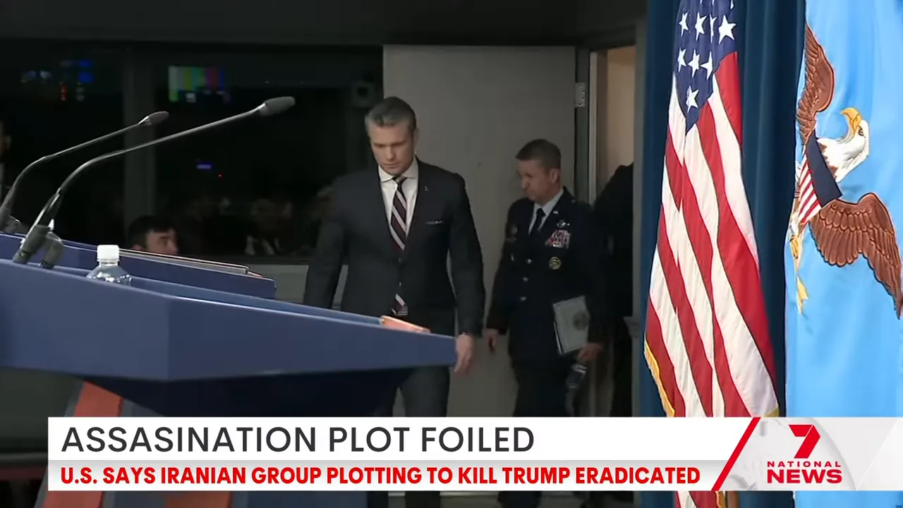 Press briefing podium with national and service flags as officials enter