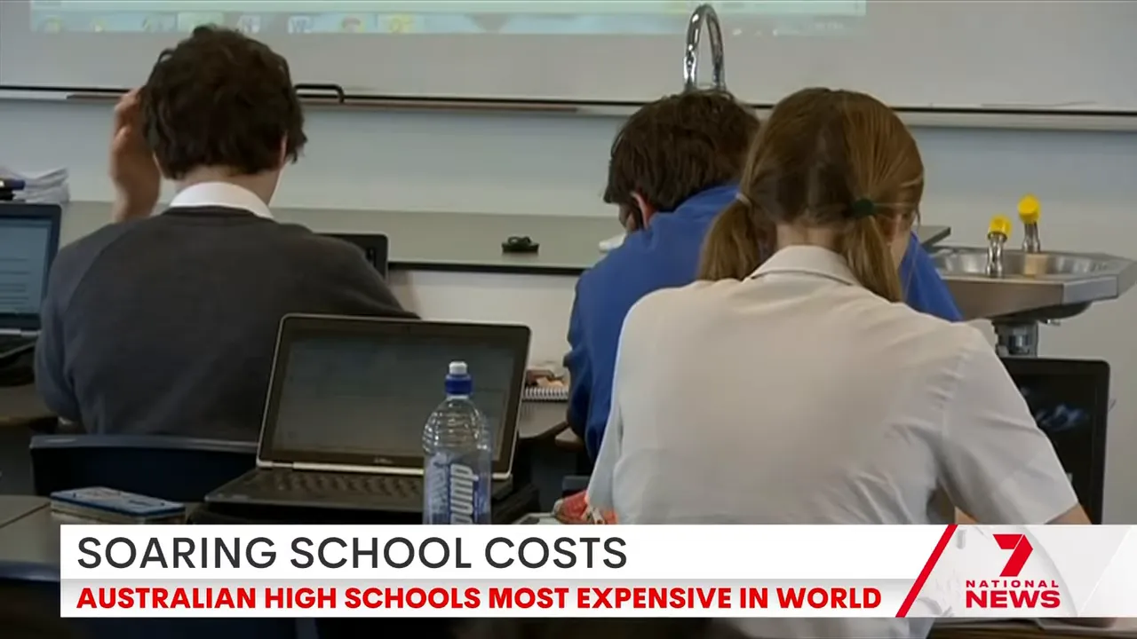 Rear view of students seated at desks using laptops and school materials, illustrating the return to school and education costs.