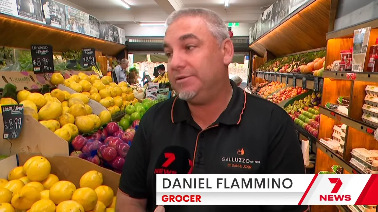 Grocer Daniel Flammino talking inside an Australian supermarket produce aisle during a fuel crisis segment