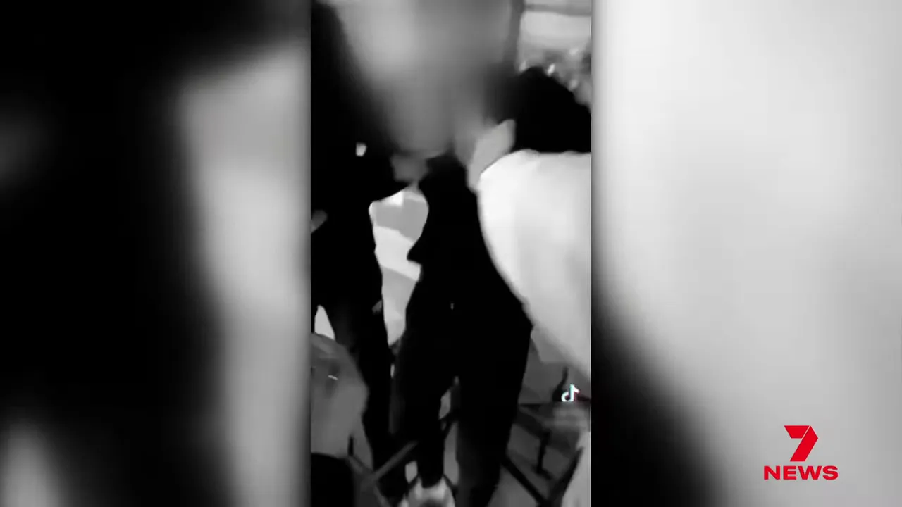 Vertical phone video still of teens confronting each other indoors with a TikTok watermark