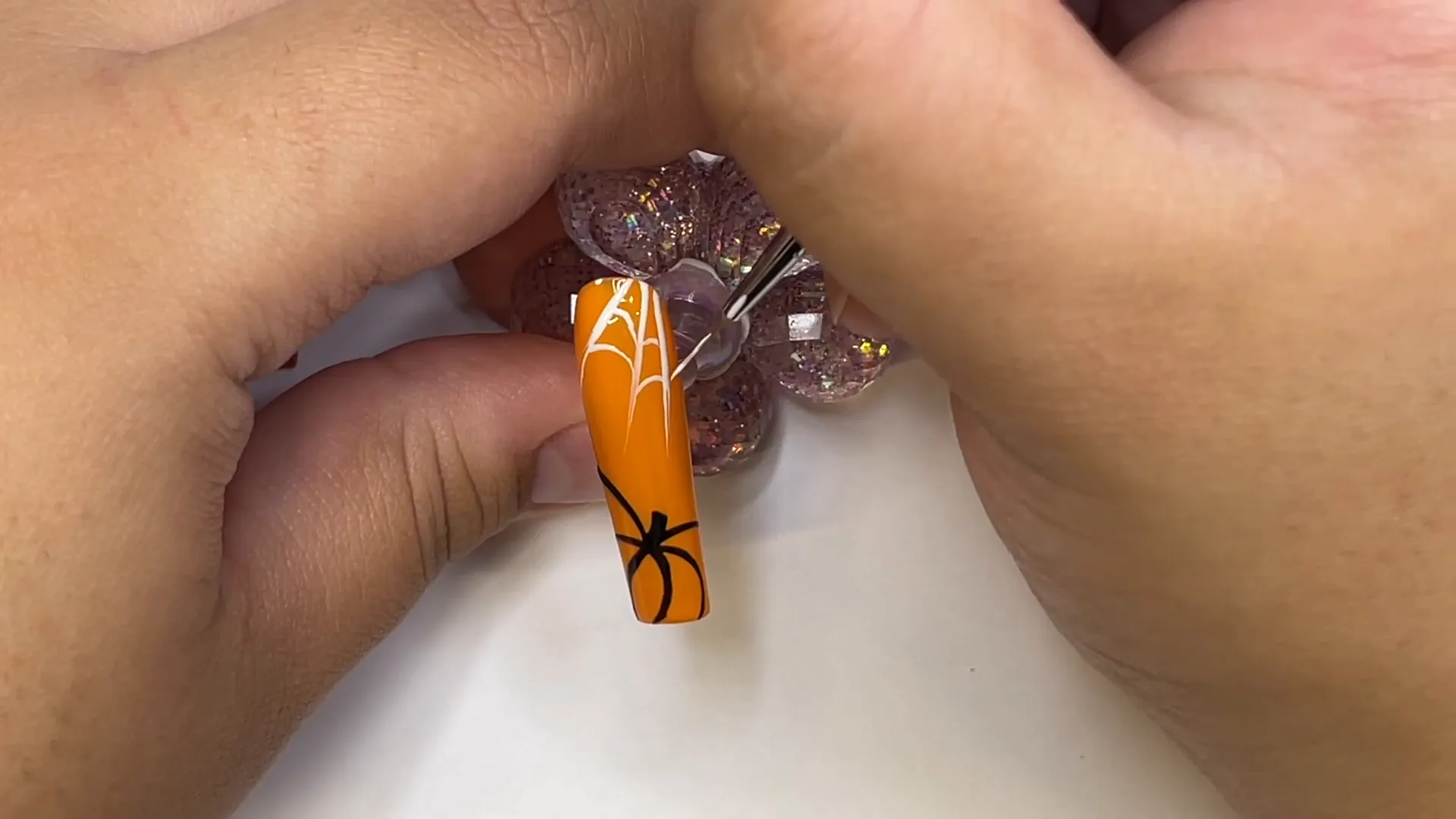 Spooktacular Halloween Nails: Easy Designs for Beginners 9 Spider web detail on pumpkin nail design