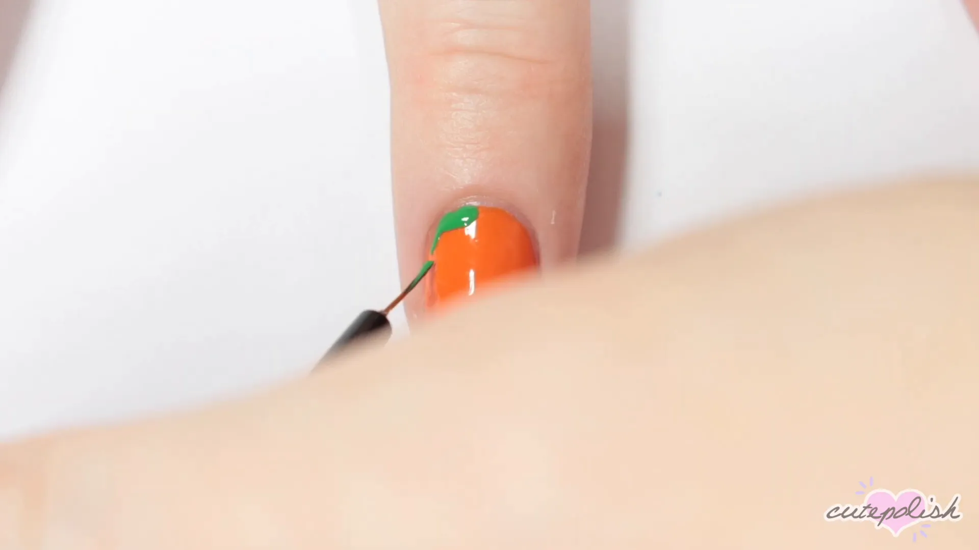 Spooktacular Nail Art: 10 Easy Halloween Designs 4 Creating the pumpkin leaves with green polish.