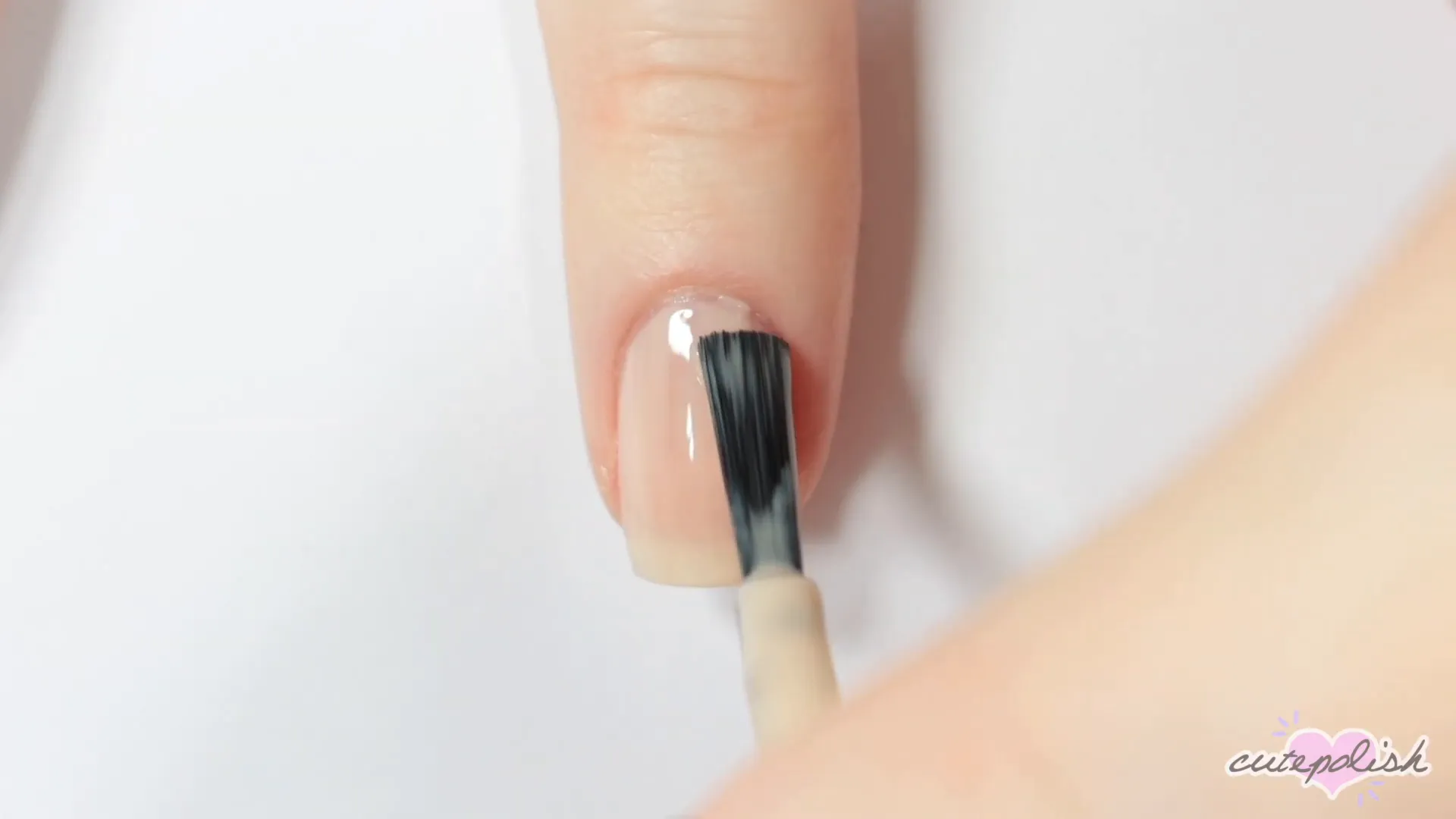 Spooktacular Nail Art: 10 Easy Halloween Designs 15 Creating the witch hat base with black polish.