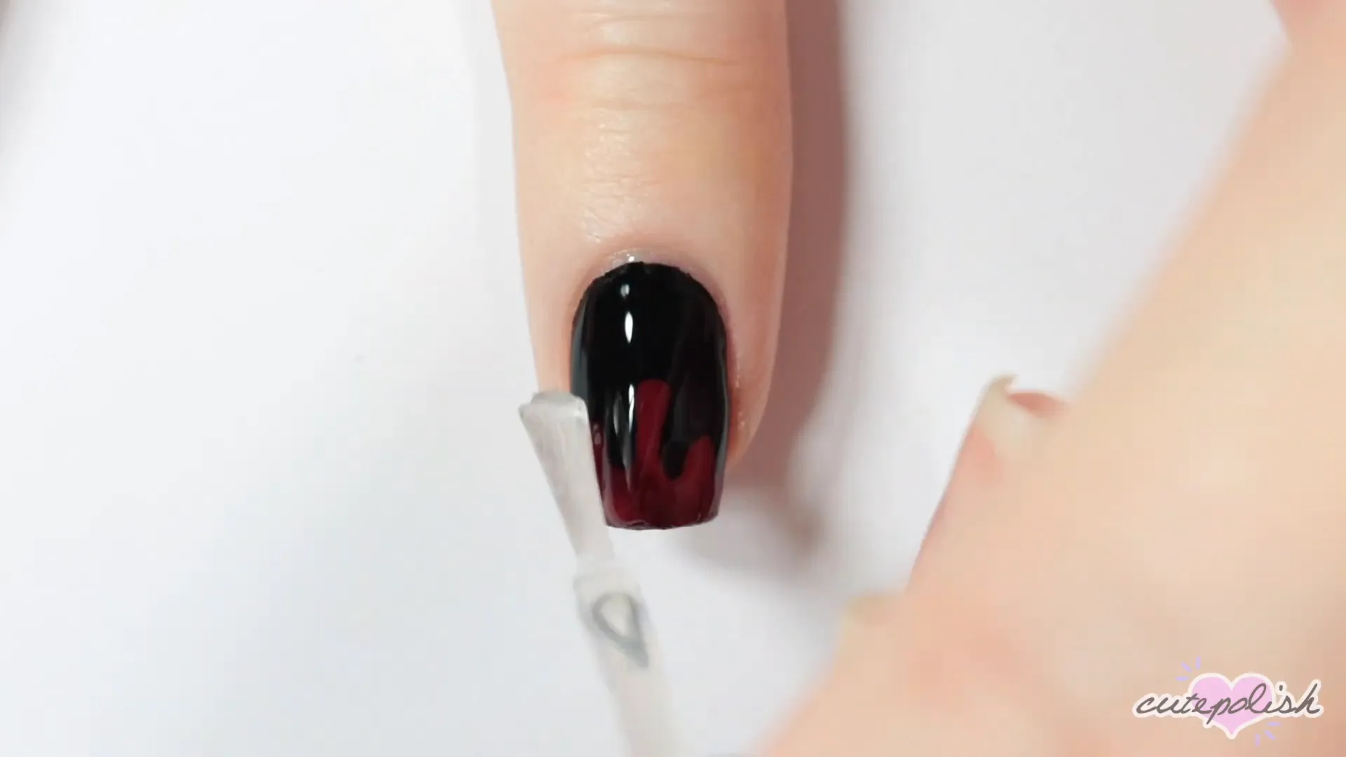 Spooktacular Nail Art: 10 Easy Halloween Designs 12 Completing the blood drip design with a top coat.