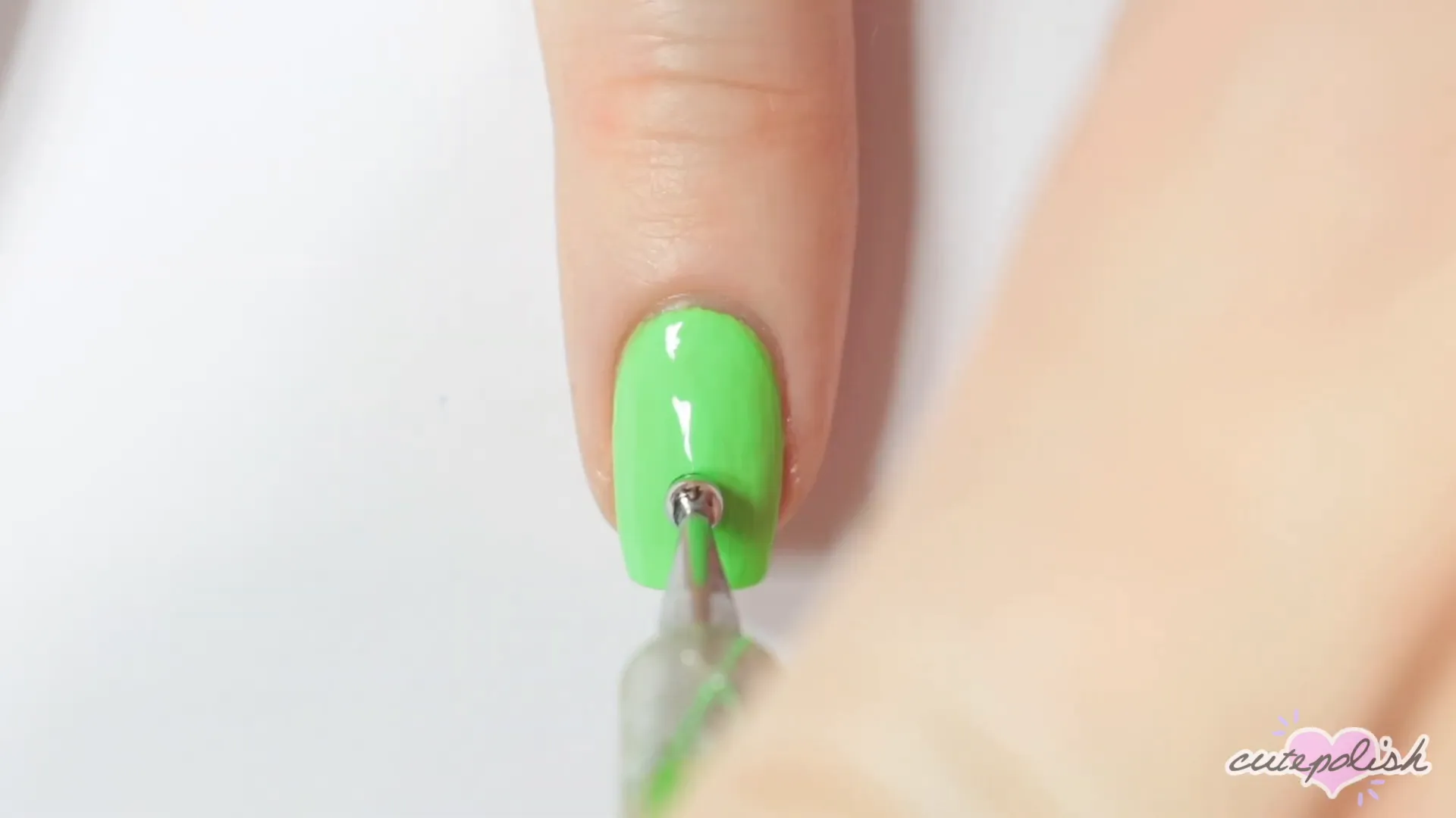 Spooktacular Nail Art: 10 Easy Halloween Designs 9 Starting the spider design with a neon green base and black dot.