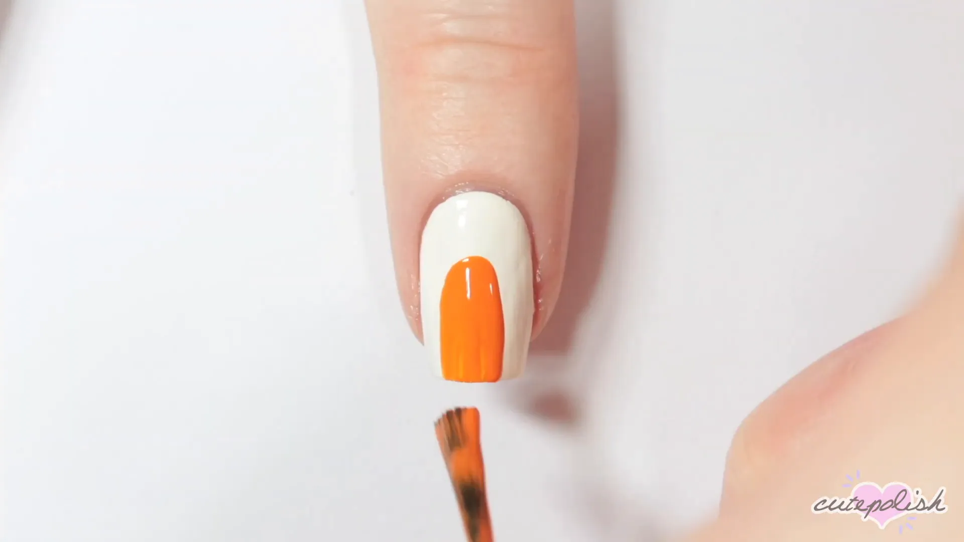 Spooktacular Nail Art: 10 Easy Halloween Designs 7 Creating the candy corn design with orange polish.