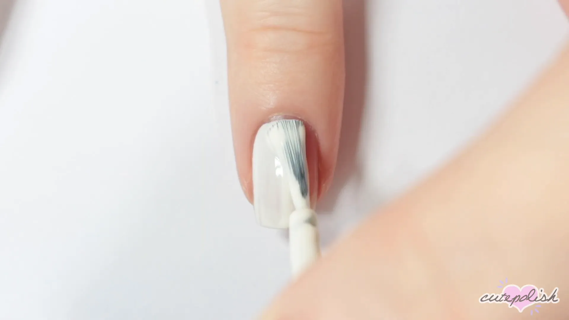 Spooktacular Nail Art: 10 Easy Halloween Designs 19 Starting the skeleton skull design with white base and black eyes.