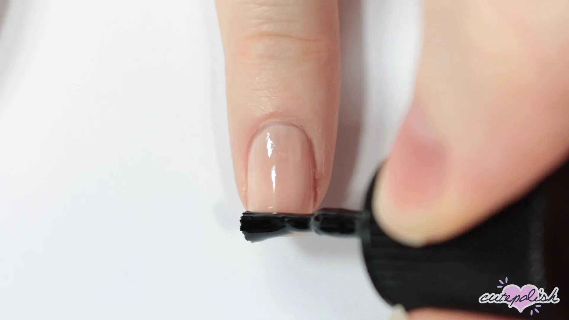 Spooktacular Nail Art: 10 Easy Halloween Designs 6 Starting the black cat design with a beige base and semicircle.