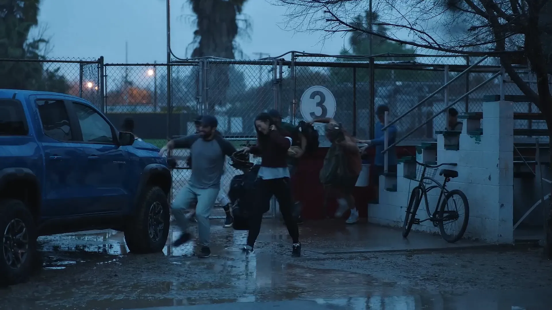 People helping neighbors with Chevy truck in the background