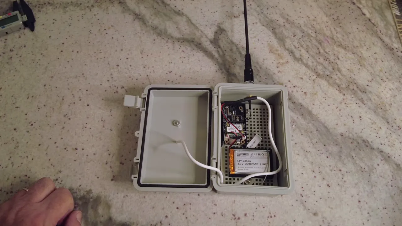 final wiring inside enclosure with LoRa SMA pigtail connected and battery visible
