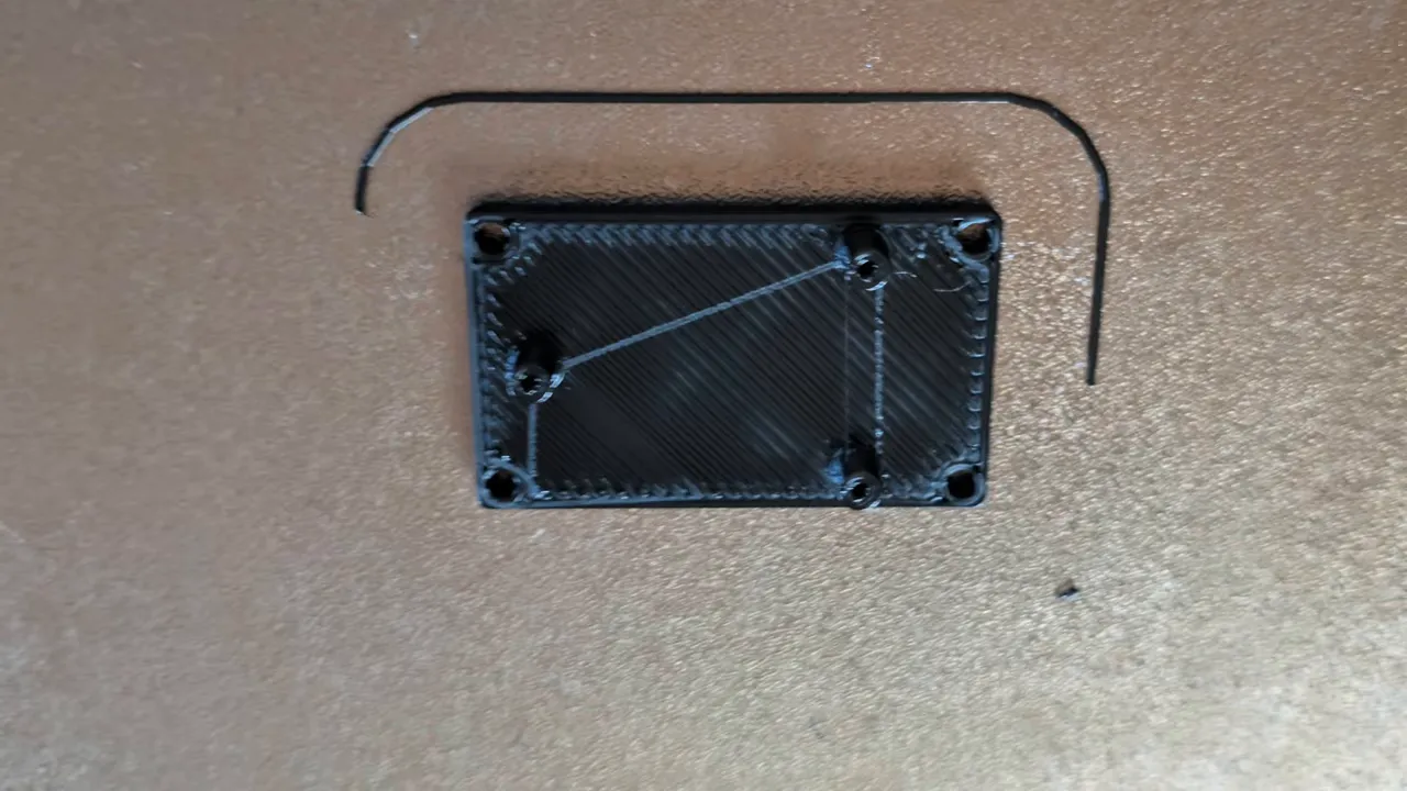 Black 3D-printed standoff with four raised mounting points