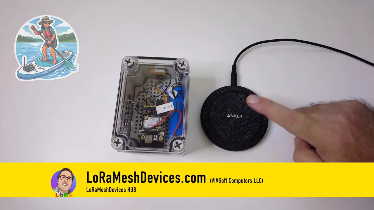 Transparent waterproof enclosure containing electronics beside a round wireless charging pad