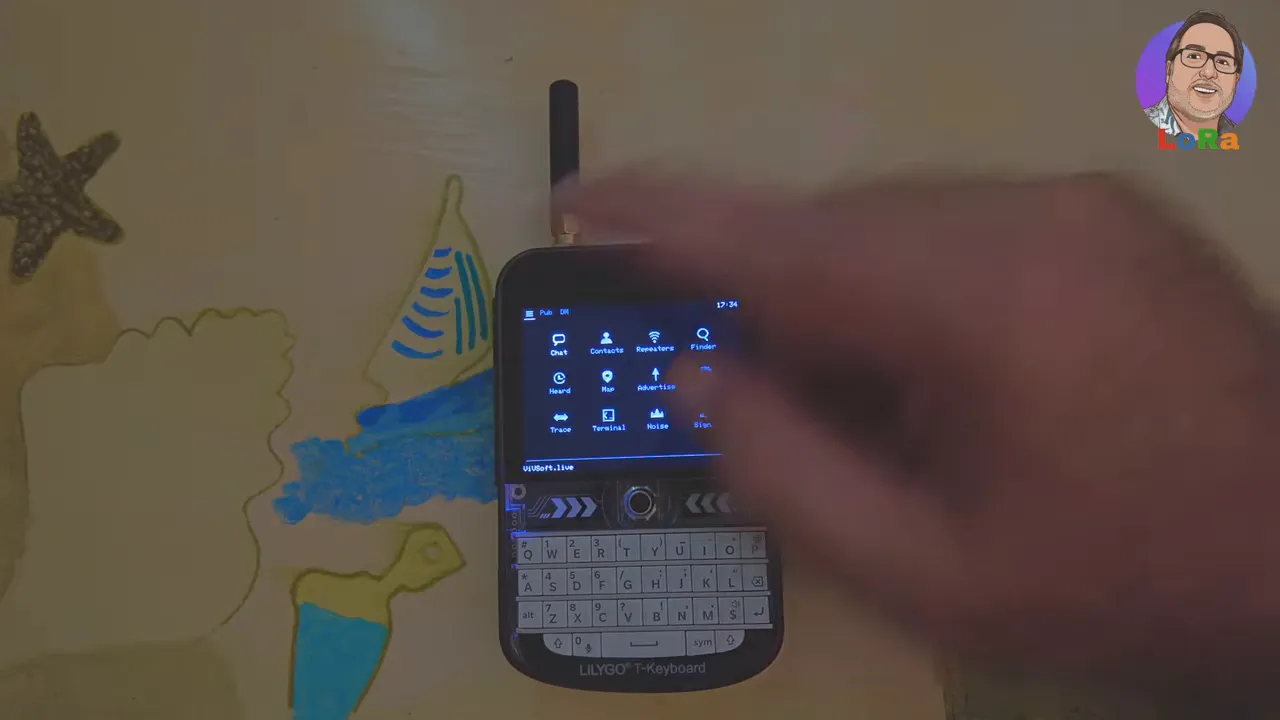 LilyGo T‑Deck home screen showing MeshOS menu tiles like Chat, Contacts, Repeaters, Finder and tools