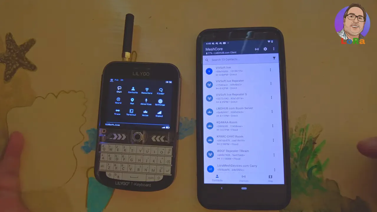 Clear view of a LilyGo T‑Deck displaying MeshOS main menu tiles next to an Android phone showing the MeshCore contacts list.