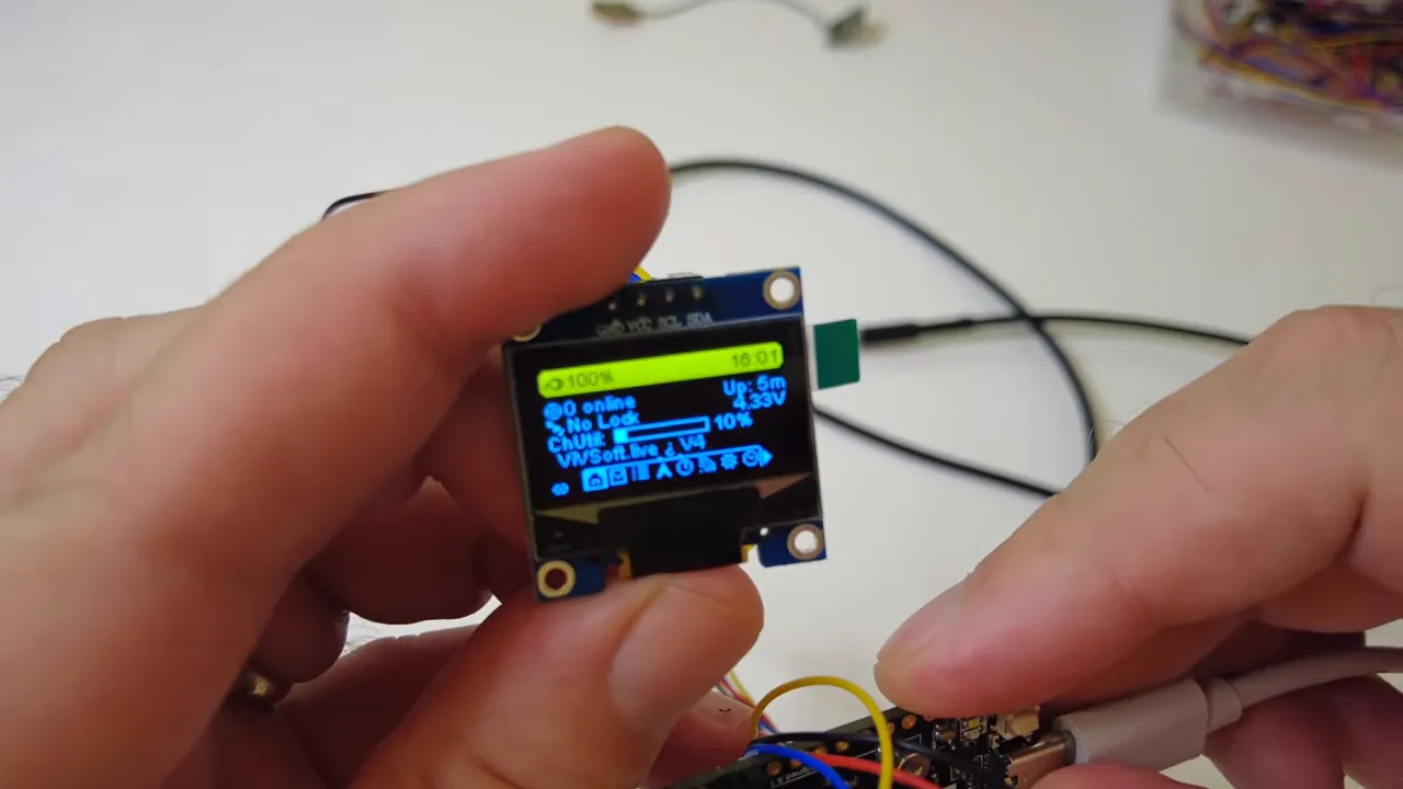 Small OLED display showing Meshtastic environmental telemetry and temperature information