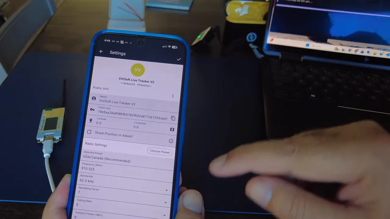 Smartphone displaying MeshCore Tracker V2 settings with latitude and longitude fields
