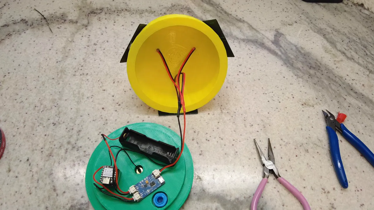 Top-down view of the Meshtastic tree node showing battery holder, charge controller, wiring and tools