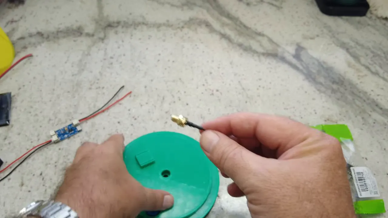Hand holding SMA pigtail connector for LoRa antenna