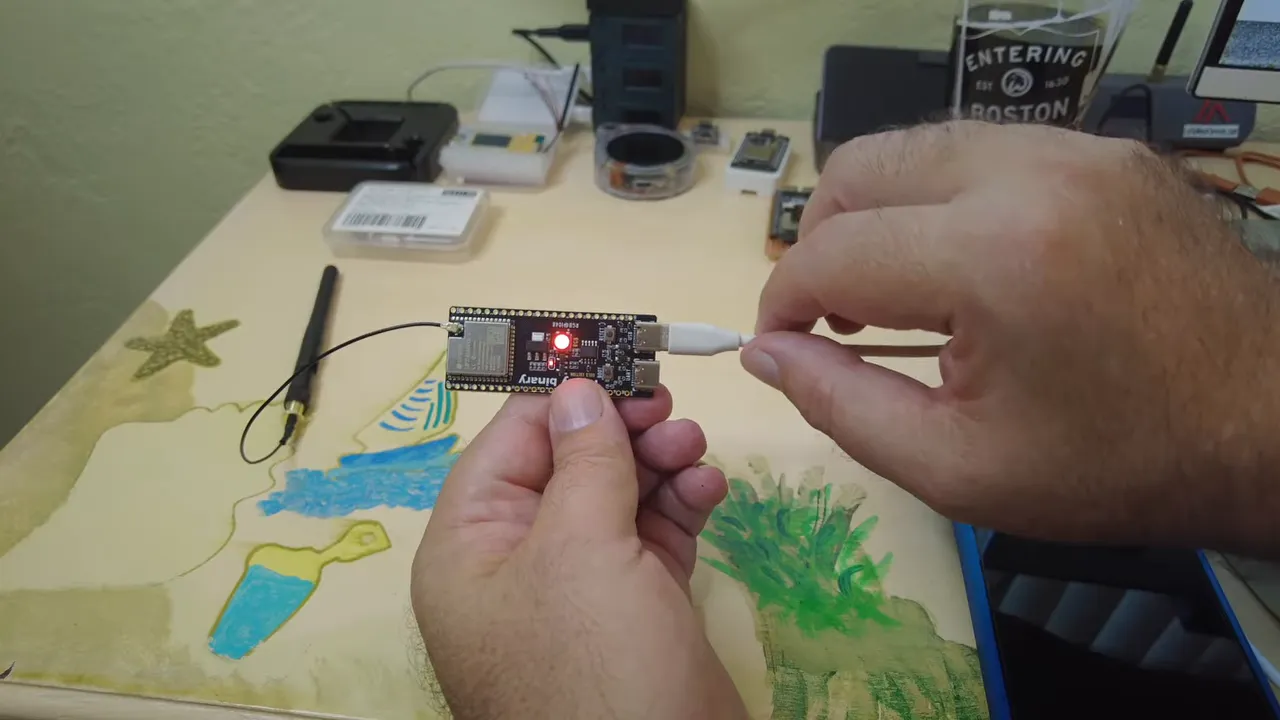 Person holding an ESP32-S3 board during the WireClaw setup
