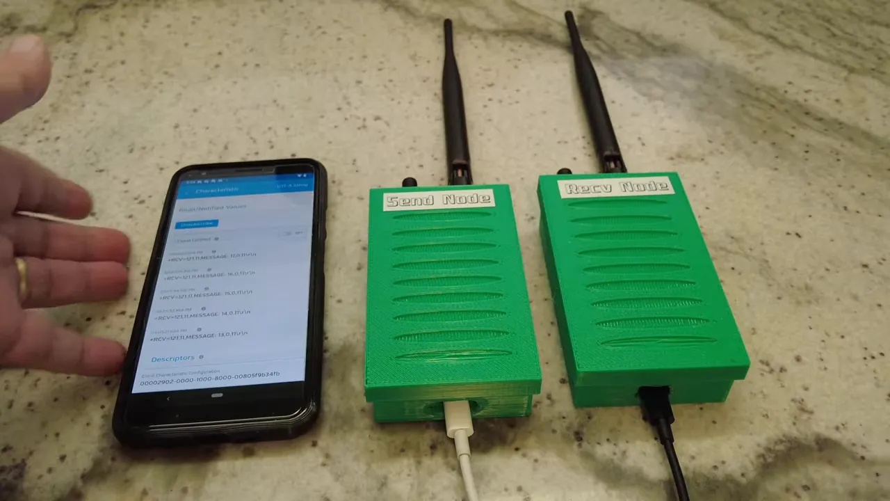 Smartphone running LightBlue with REYAX RYLR999 send and receive nodes and external antennas on the workbench