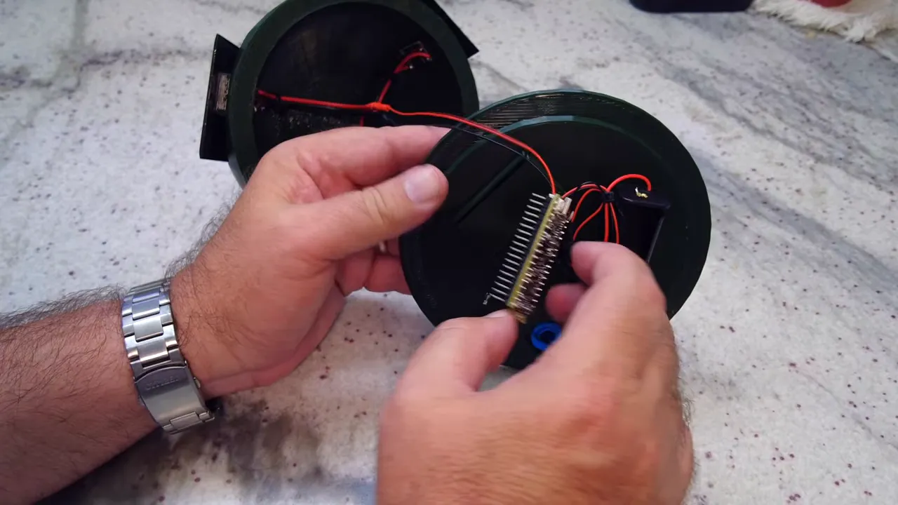 Hands installing the SMA antenna connector inside the Solar Meshtastic tree node V2 enclosure before powering