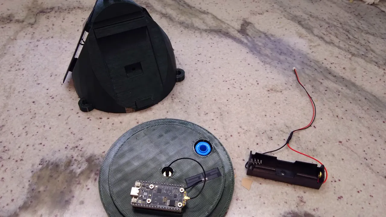 Solar Meshtastic tree node components laid out including the Heltec board, battery leads, and enclosure