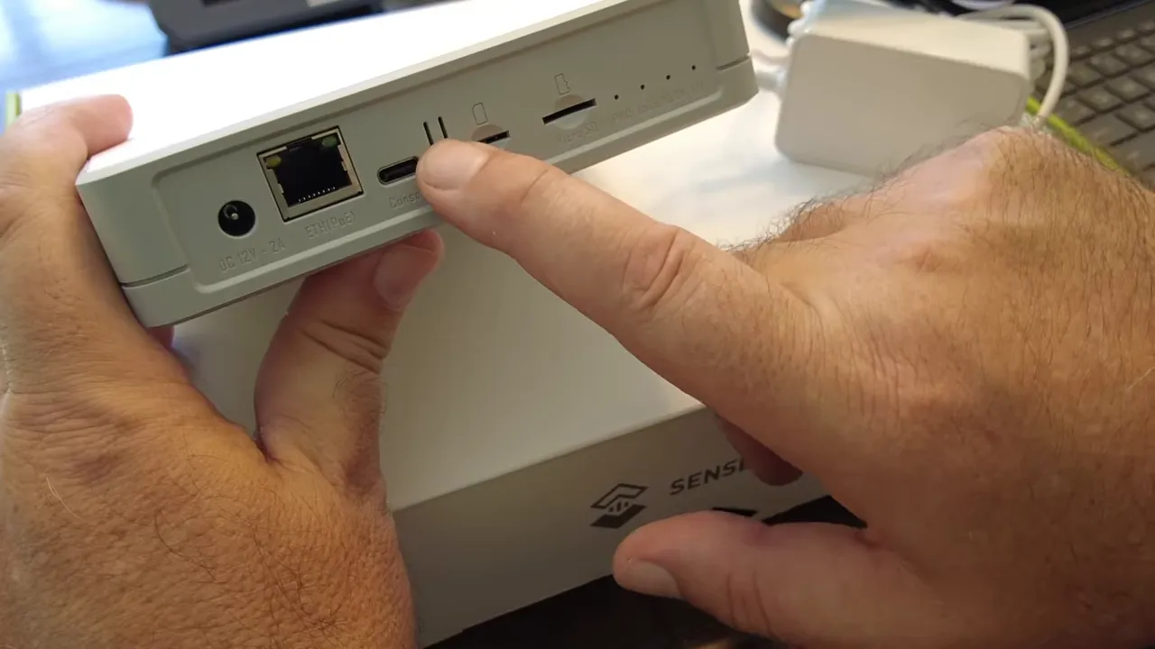 SenseCAP M2 hotspot mode button being pressed and held