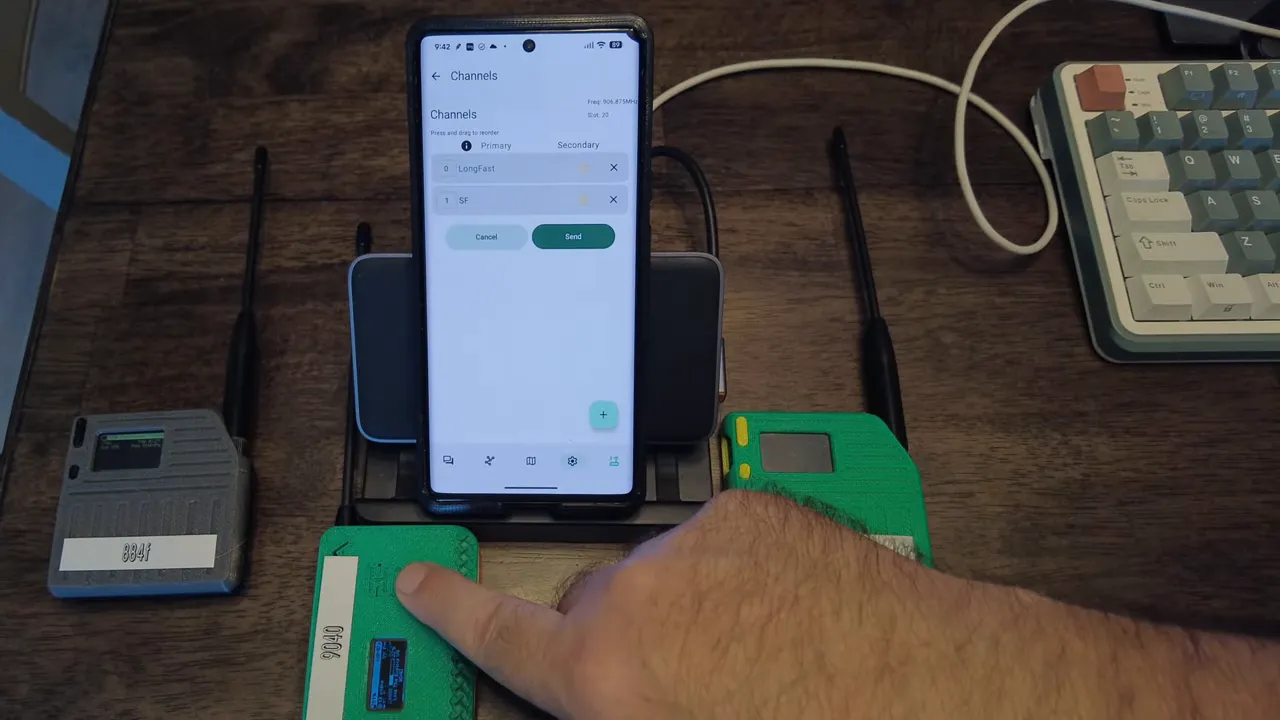 Meshtastic app channels screen showing LongFast and SF on a phone while a finger points at nearby nodes.