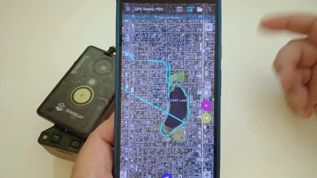 Phone displaying a cyan GPS route over satellite imagery in GPX Viewer
