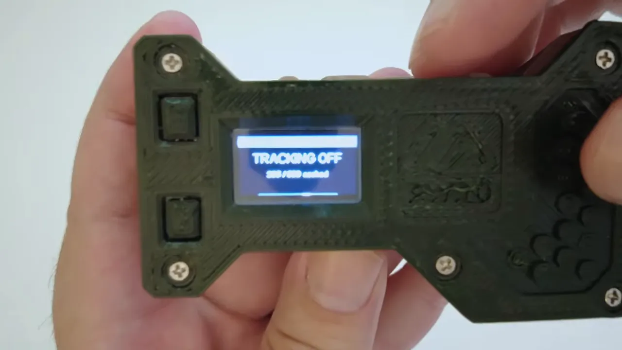 Handheld T096 with its screen showing tracking off and a cached point count