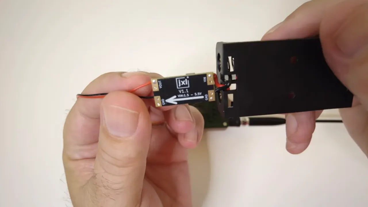 Close view of the AA battery holder connected to a small buck boost converter board