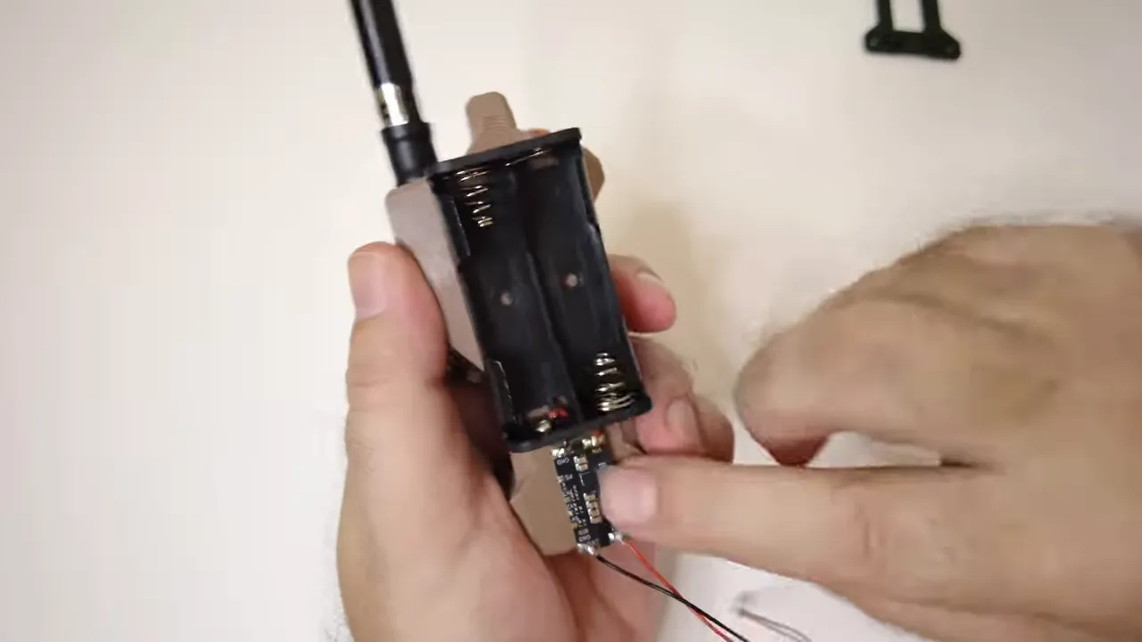 AA battery holder taped to the back of the case with the buck boost converter mounted below it